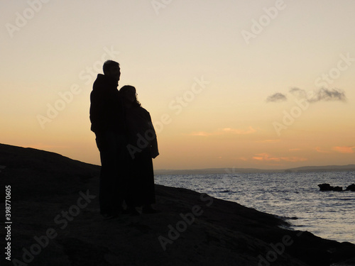 silhouette of a couple on the beach sunset