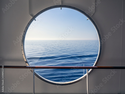 View through porthole with Blue Sea and view to horizon 