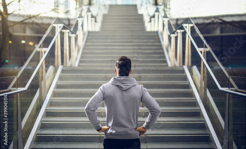 Man in hoodie preparing for stair run.