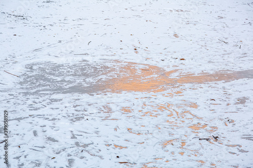 Textured winter surface of frozen water with ice and white snow