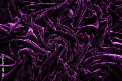 Folds of deep purple velvet material, background