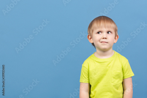 People child looks away, face expresses doubt, disbelief, curiosity, dilemma, guesswork, imagination, planning and mischief. Cunning kid suspects something, copy space.