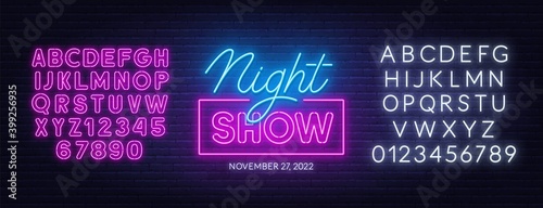 Night show neon sign on brick wall background. Pink and white neon alphabets. Template for the design.