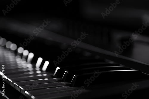 White and black piano keys in the dark
