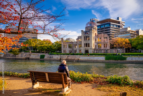 Senior man looking at Hiroshima Peace Memorial building, Japan