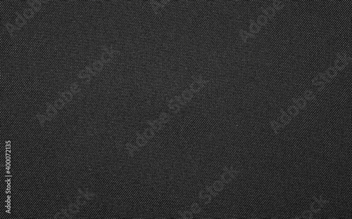 Synthetic black nylon fabric.Texture of dense black fabric.The background is nylon black.