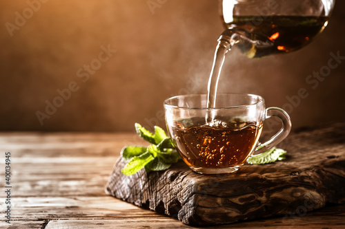 Cup of hot tea with fresh mint leaves