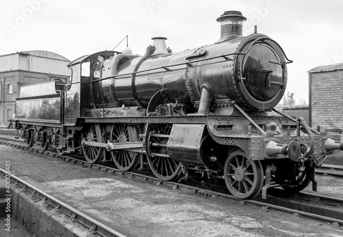 Steam engine on a railway track. Industrial revolution heritage.