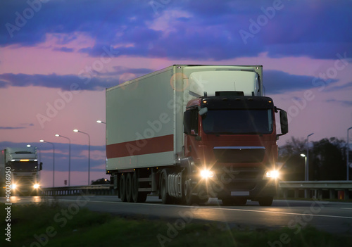 Trucks move at dawn on highway