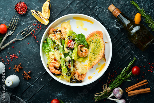Salad of shrimp, olives, pine nuts and lettuce. Top view. Free space for text.
