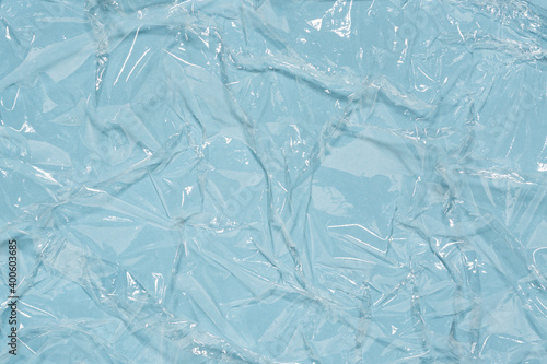 Wrinkled cling film, blue vinyl art background, wet effect texture.