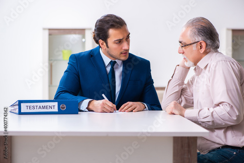 Young male lawyer visiting old man in testament concept