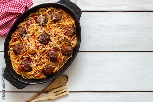 Meatballs with spaghetti, tomato sauce and parmesan cheese. Italian cuisine.