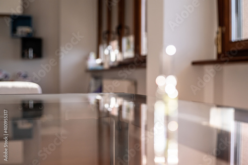 Glass surface with bokeh and reflect on home interior backdrop. Empty template for product. Text space.