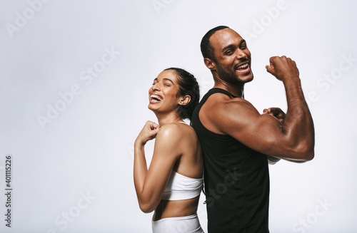 Cheerful fit couple on white background