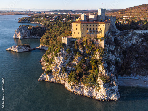 Aerial view of gothic Duino castle on a cliff over the Gulf of Trieste , Italy. 