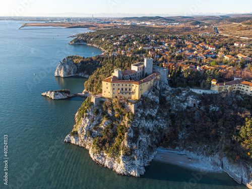 Aerial view of gothic Duino castle on a cliff over the Gulf of Trieste , Italy. 