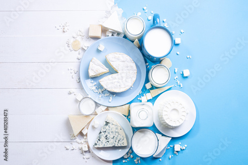 Dairy products on white wood and blue background with copy space. Top view , flat lay.