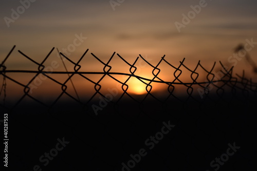Sunset barbed wire fence