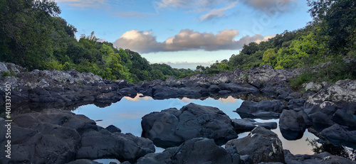 Reflection of clouds in a pond, tropical river and canyon of Reunion island, France, Tropical Europe.