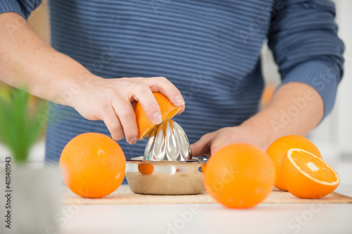 cropped view of man with orange squeezer