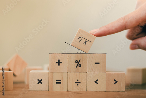 Math symbols written on the wooden blocks of a businessman With calculations with ideas A concept, a difficult problem or a mathematical solution