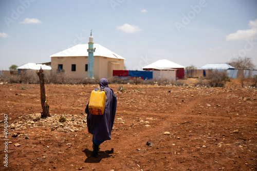 Kids walking home after water distribution during deadly drought in Somalia
