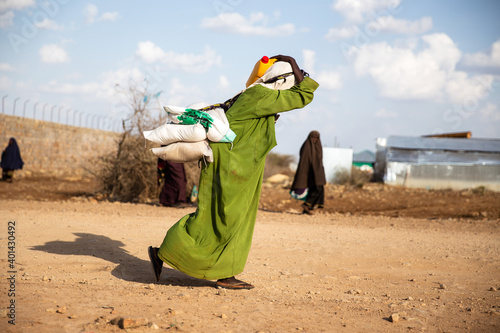 Woman walking home after food distribution during deadly drought in Somalia