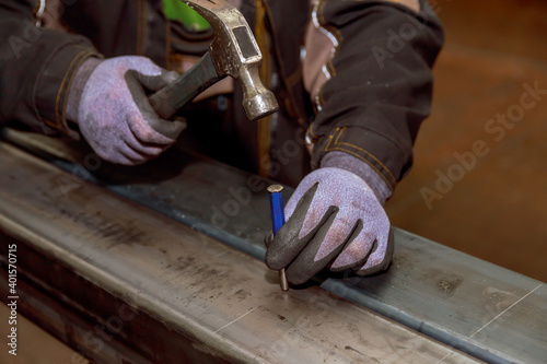 Hammer, nail punch. marking on a metal surface for drilling holes with a square and a caliper.