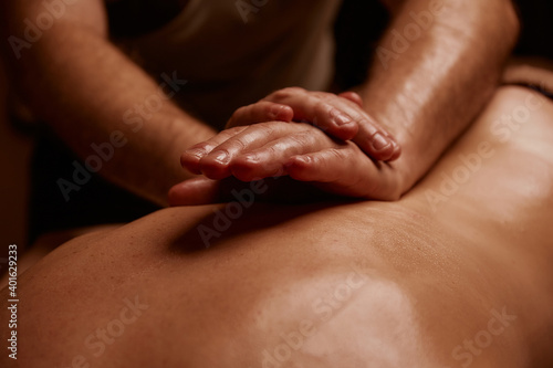 Girl getting back massage. Spa salon