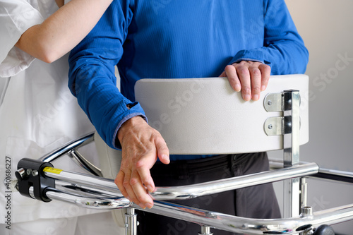 Physiotherapist assisting a patient with Amyotrophic Lateral Sclerosis. High quality photo