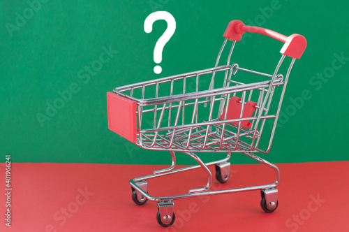 An empty shopping cart on a red and green background. The concept of reducing purchasing power and inflation.