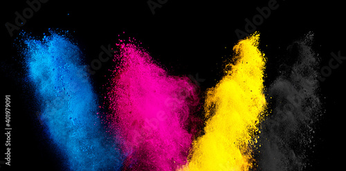 colorful CMYK cyan magenta yellow key holi paint color powder explosion isolated dark black background. printing print business industry manufacturing beautiful party festival concept
