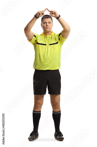 Full length portrait of football referee gesturing a VAR symbol
