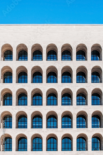 Modern square building with arched windows. Building with arched windows. New classicism geometric building. Eur district Rome.