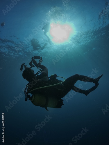 scuba diver photographer underwater taking photos blue ocean scenery of scubadiver with hobby