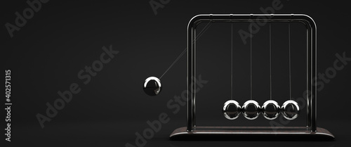 Newton's cradle poster. The pendulum in action. Dark background.