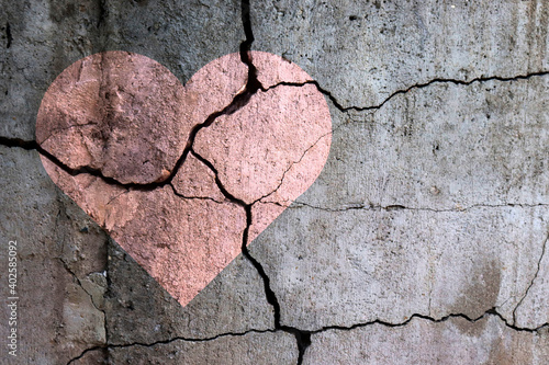 A broken heart. Drawing of a heart on a cracked wall. Broken relationships. Treason and betrayal. Past love. A quarrel.