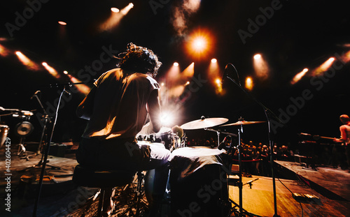 silhouette of drummer playing drums on a concert