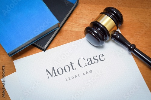 Moot Case. Document with label. Desk with books and judges gavel in a lawyer's office.