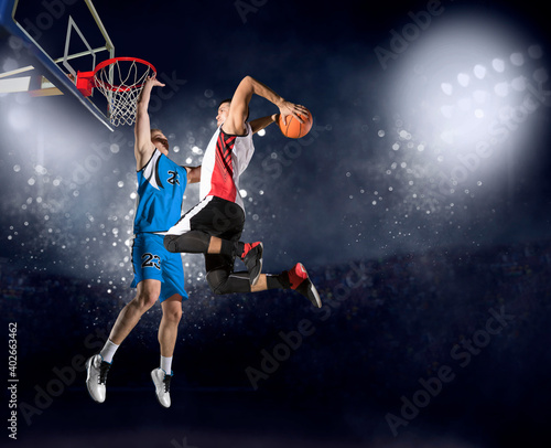 Two basketball players in arena. Blocked shot
