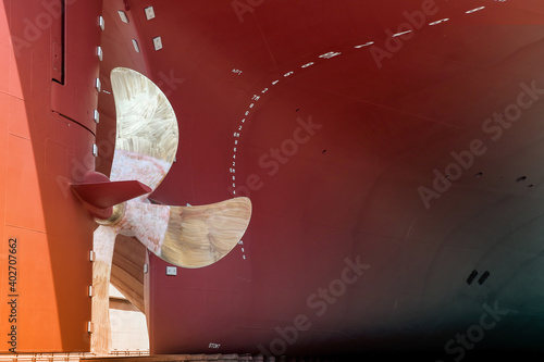 industry shipyard, Close up Rudder with Propeller at stern of big ship during maintenance at floating dry dock Thailand