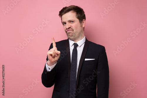 Mature man showing refusal gesture. It is not for me, leave me in piece, has angry expression.