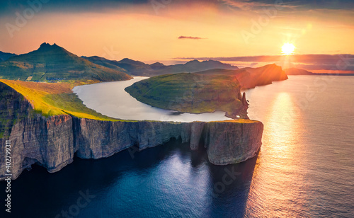 Magnificent evening view from flying drone of Sorvagsvatn lake, Vagar, Faroe Islands, Denmark, Europe. Majestic summer sunset on Atlantic Ocean. Beautiful summer scenery..