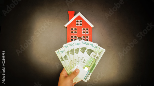 Economical concept of money for buying a house. Concept for real estate house price, selling, buying, rent, and loan (Translation: Korean money)