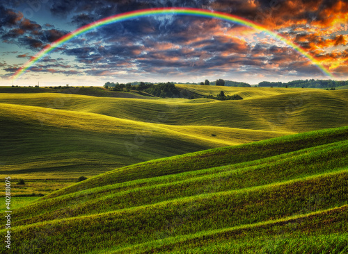 Scenic view of rainbow over green field 