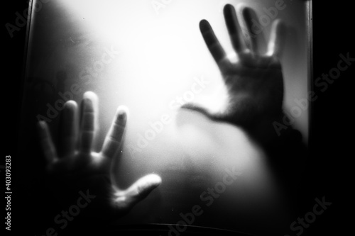 scary picture of hands behind glass