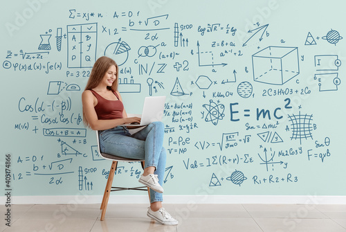 Young woman with laptop studying exact mathematical sciences. Concept of online education