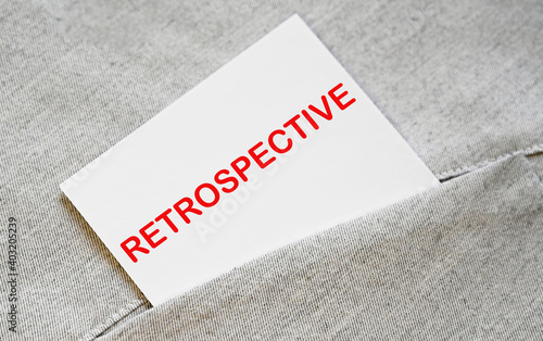 RETROSPECTIVE text on the white sticker in the shirt pocket.
