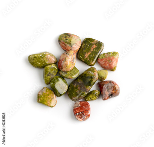 Unakite pebbles isolated, pink and green altered granite stones